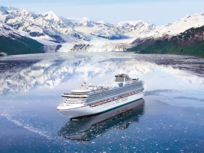 Princess Cruises ship floating in front of a majestic glacier