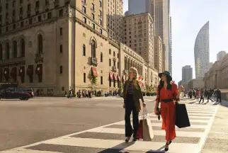 Two woman walk across a zebra crossing in Toronto