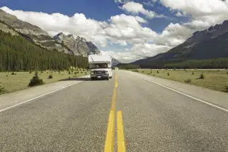 A motorhome drives along the Icefields Parkway in Canada