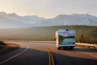 a motorhome drives along a scenic highway in Canada