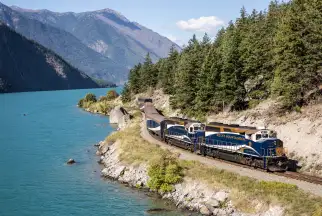 The Rocky Mountaineer train winding along the shores of Seton Lake