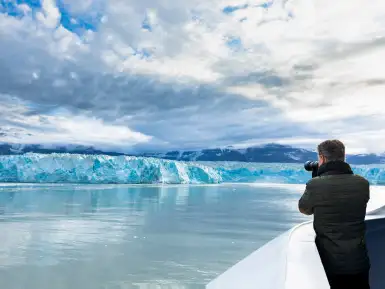 A man photographs the Hubbard Glacier from a cruise ship