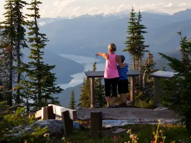 Mother and son are enjoying the views from a viewing platform along the Meadows in the Sky Parkway at Mount Revelstoke National Park