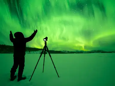 A man photographing the northern lights in Yukon
